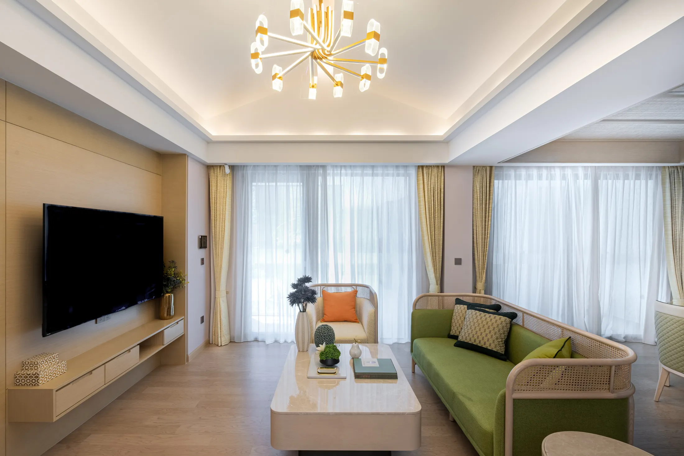 Bright, tidy living room with natural textures and a soft green sofa