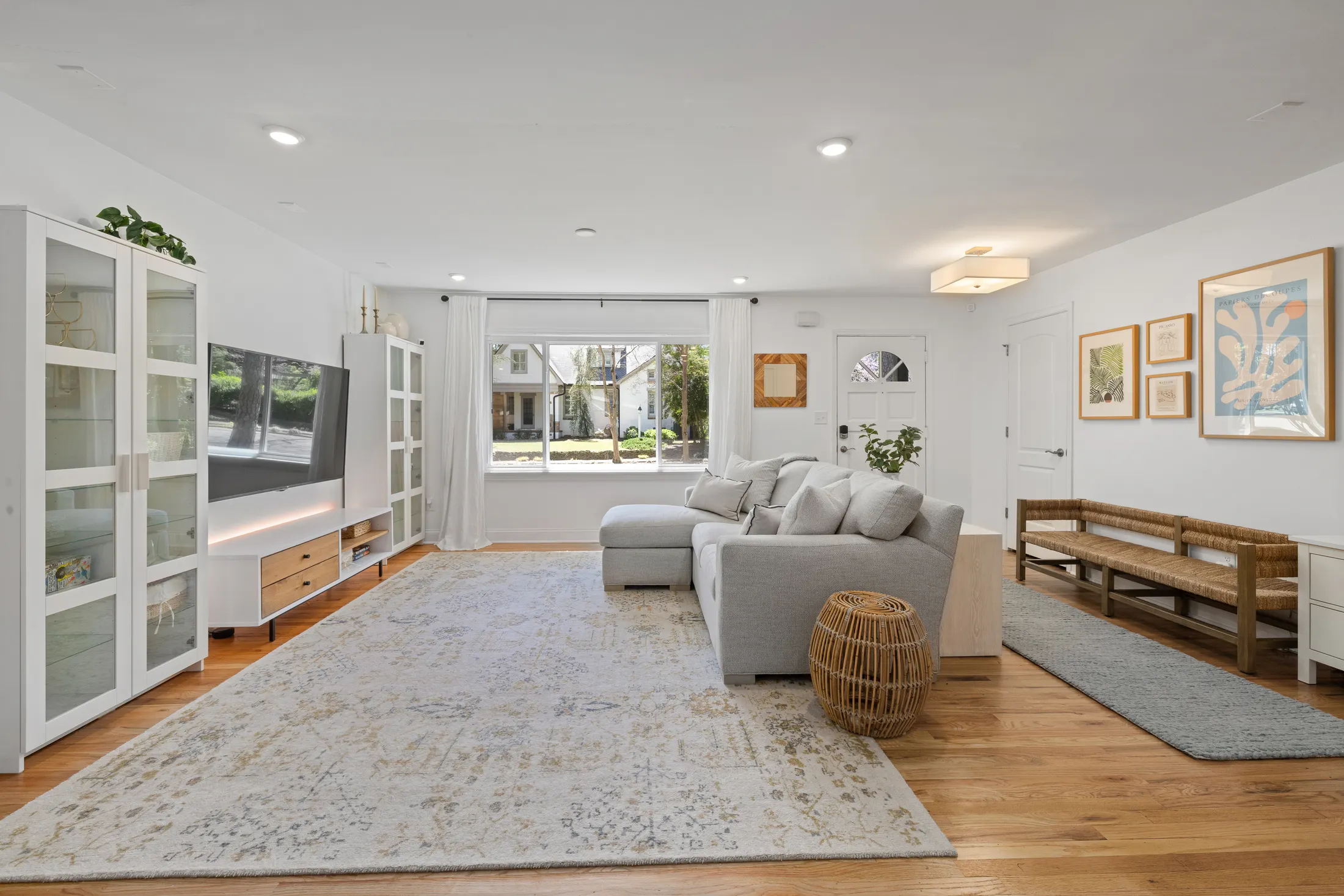 Bright, beautifully presented living room with soft neutral furnishings and natural timber